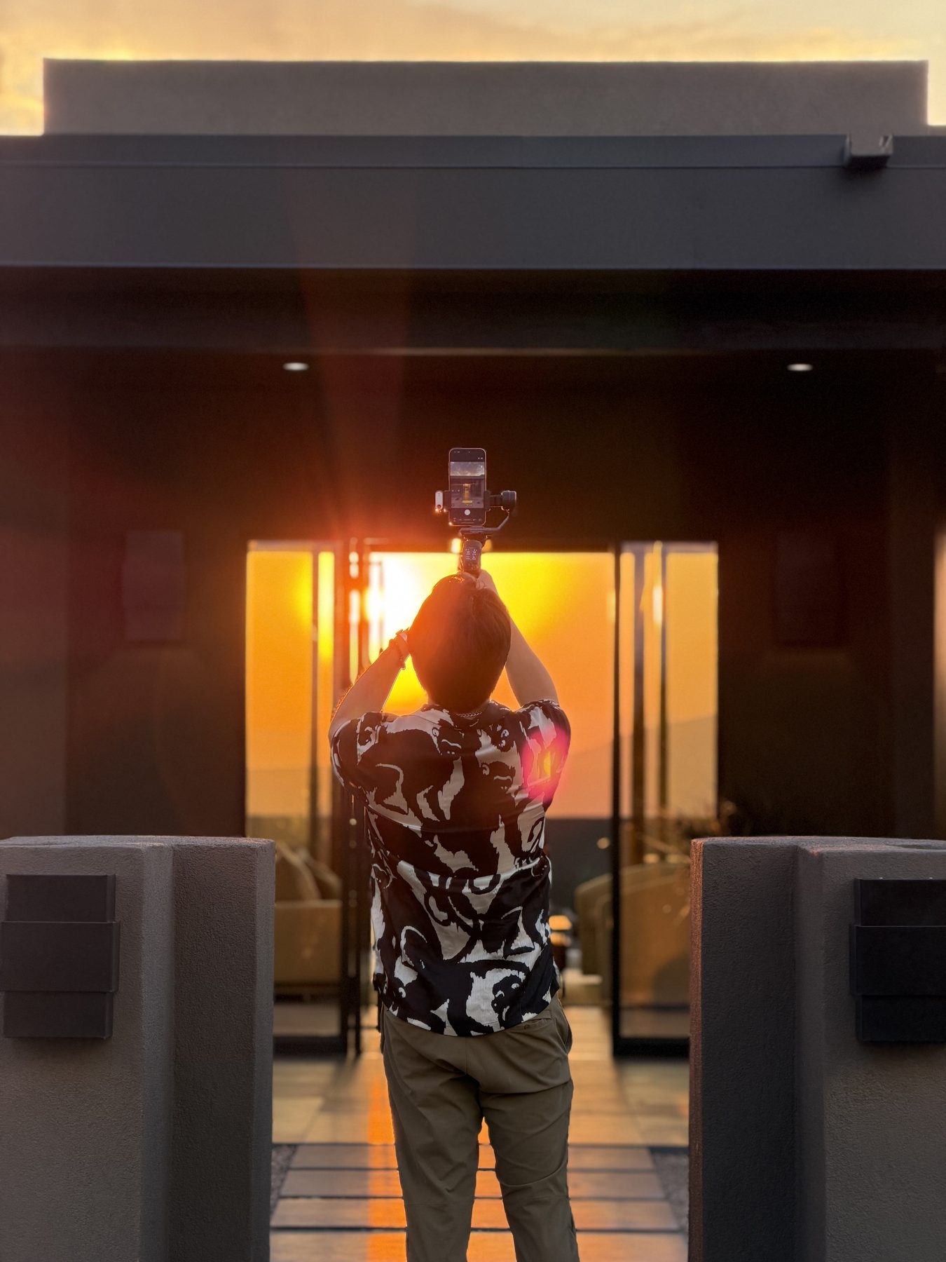 Aram filming into the sunset through a modern breezeway